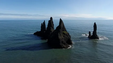 Aerial shot of four sharp rocks in the ocean (iceland) Stock Footage 86152542