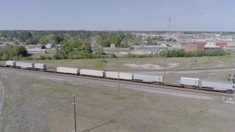 Aerial shot of freight train passing quickly through American town 2 (4K) Stock Footage 127763731