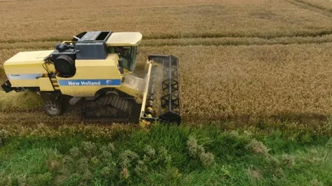 Aerial shot of a functioning combine harvester from near flying drone in autumn Stock-Footage 143171278