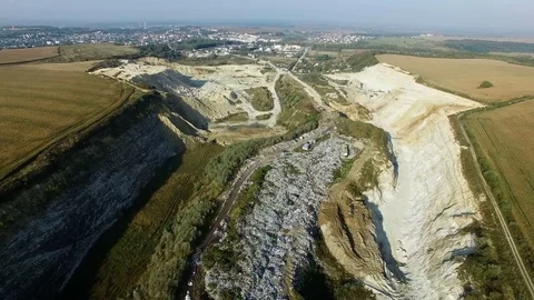 Aerial shot of garbage dump between agricultural fields. Stock Footage 80976917