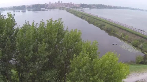 Aerial shot going over tree revealing a city Stock Footage 45968257
