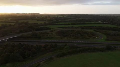 Aerial shot of green fields with a rainy sunrise, 4k Stock Footage 252077392