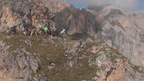 Aerial shot of a group of climbers pull the rope. Emergency rescue evacuation if Stock Footage 97177964