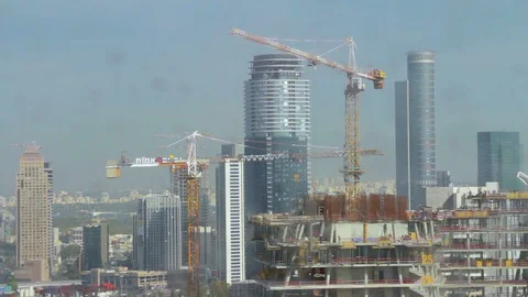 Aerial shot of a group of cranes working together at a large construction sit Stock Footage 128463233