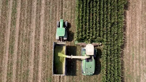Aerial shot of harvester loading off corn Stock Footage