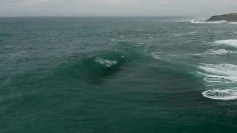 Aerial shot of heavy wave exploding onto a shallow rock ledge. Stock Footage 131611204