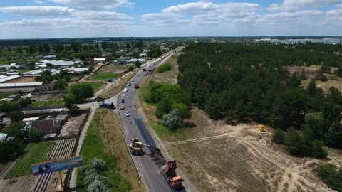 Aerial shot of a highway repairing, blacktopping, excavating, in summer Stock Footage