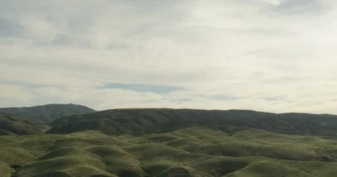 Aerial shot of hilly landscape and small river, cloudy day Video stock 104713402