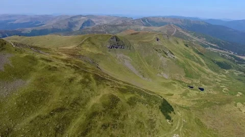Aerial shot of a huge mountaneous range in the Carpathians on a sunny day Stock Footage 86791473