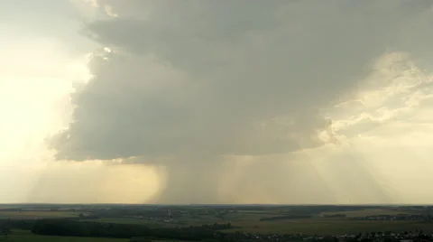 Aerial shot with huge raining cloud and sun rays passing through it. UHD 4K Vídeo Stock 46231579