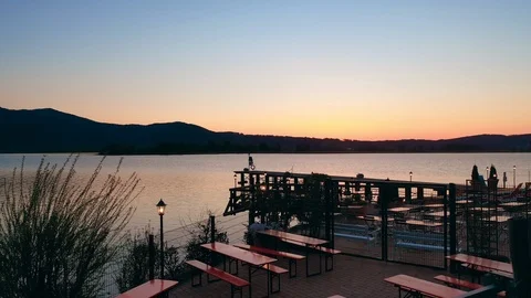 Aerial shot inward a little restaurant at a lake with wooden bridge Stock Footage