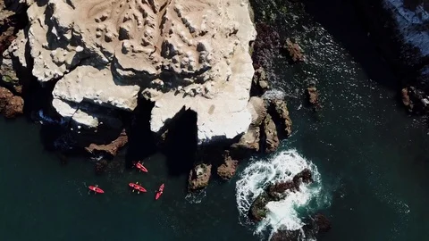 Aerial Shot of La Jolla Cliffs and Kayakers as drone shoots straight down Stock Footage 87919074