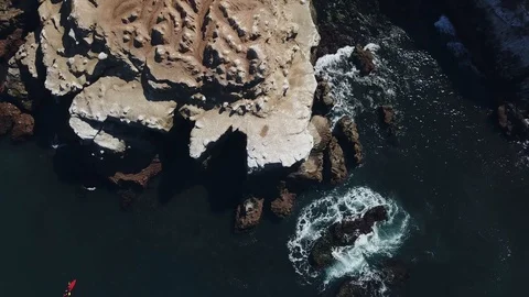 Aerial Shot of La Jolla Cliffs and Kayakers as drone shoots straight down Stock Footage 87919156