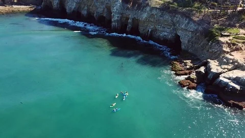 Aerial Shot of La Jolla Cliffs and Kayakers as drone moves toward cliffs Stock Footage 87919381