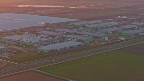 Aerial shot of a large industrial data center campus at sunrise, with a highway Stock-Footage 332680732