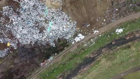 Aerial shot of a large open garbage dump on the outskirts of the city Stock Footage 196991803