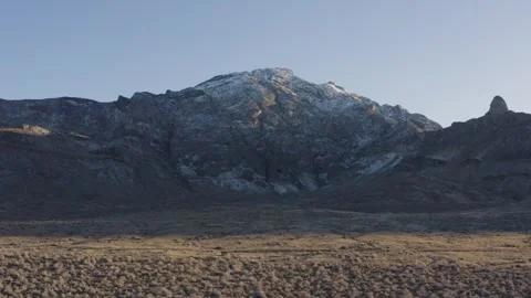 Aerial shot of a large snow-capped mountain in an arid plain, Salt Lake City, US Stock Footage 287724791