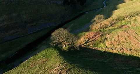 Aerial shot of light and shadows in a valley Stock Footage 335053935