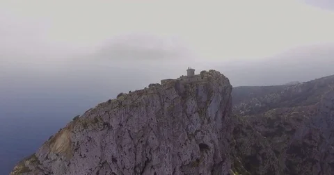 Aerial shot from lighthouse at cloud altitude in cliffs 4k Video stock 84707517