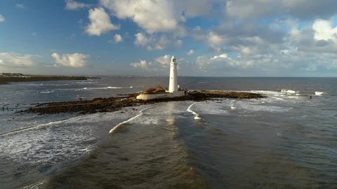 Aerial shot of Lighthouse with waves lapping up around it 動画素材 125208740