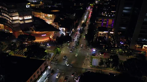 Aerial shot of lively intersection at night with shopping mall. Mexico City. Stock Footage 296283213