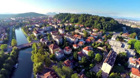 Aerial shot of Ljubljana city with Ljubljanica and castle at sunset Stock Footage