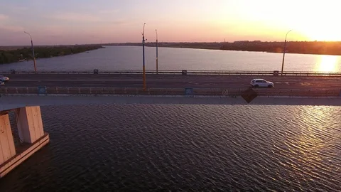 Aerial shot of a lofty bridge over the Dnipro at shining sunset in summer 動画素材 115437652