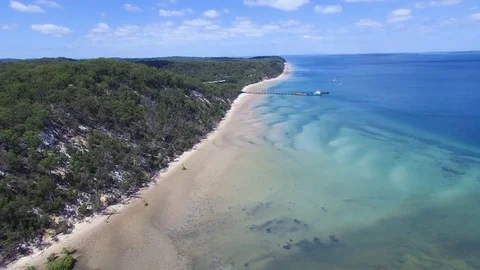 Aerial shot of a long shoreline and blue ocean Stock Footage