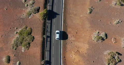 Aerial shot. Looking down. Car go new ideally flat asphalt road. Fresh white Stock Footage 146090142