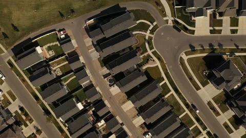 Aerial shot looking down on dense suburban housing development with park Stock Footage 130667545