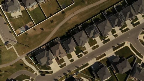 Aerial shot looking down on dense suburban housing development with park Stock Footage 146924076
