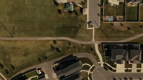 Aerial shot looking down on dense suburban housing development with park Stock Footage 146924505