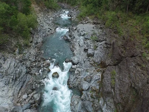 Aerial Shot Looking Down Flying Through Rocky River Canyon With White Water 스톡 동영상 71182995