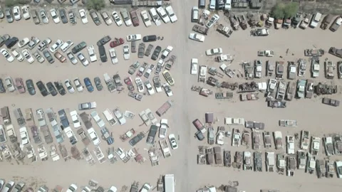Aerial shot looking down at a huge car breakers yard Stock Footage 192585713