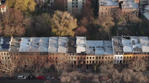 Aerial shot looking down at rows of Brownstones in Brooklyn Stock Footage 257564199