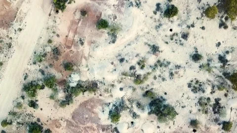 Aerial shot looking straight down showing dispersed opal mining holes in Stock Footage 108708646