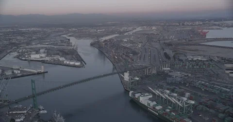 Aerial shot, low light, circular pan on bridge over shipping port, drone Video stock 115281398