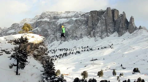 Aerial shot of man almost falling from rope in the mountain Stock Footage 47671513
