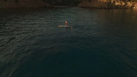 Aerial shot of man practising paddle board at sunset on stunning place 스톡 동영상 154906766