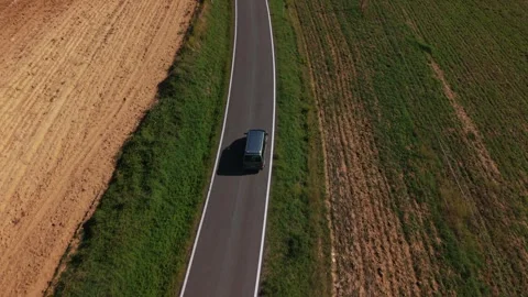 Aerial shot of a modern car van driving on a road in Tuscany farmland landscape Vidéo 320593853