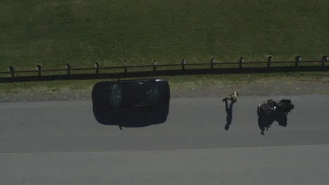 Aerial shot of Motorcycle Cop Pulling over Sports Car for Traffic Violation Stock Footage 222006235