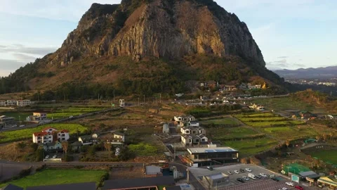 Aerial shot of mountain, cliffs and seaside village,Jeju Island,South Korea Stock Footage 245953913