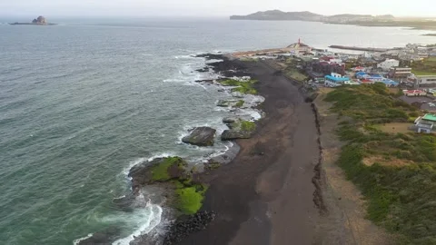 Aerial shot of mountain, cliffs and seaside village,Jeju Island,South Korea Stock Footage 245953939