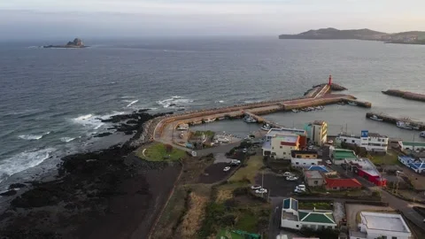 Aerial shot of mountain, cliffs and seaside village,Jeju Island,South Korea Stock Footage 245953954