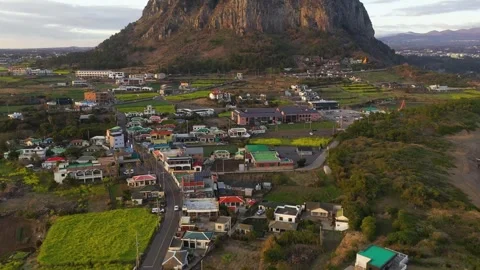 Aerial shot of mountain, cliffs and seaside village,Jeju Island,South Korea Stock Footage 245953955