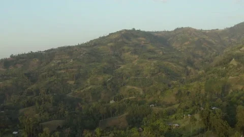 Aerial shot of a mountain with fields and typical houses at sunset, in Ethiopia Stock Footage 230631767