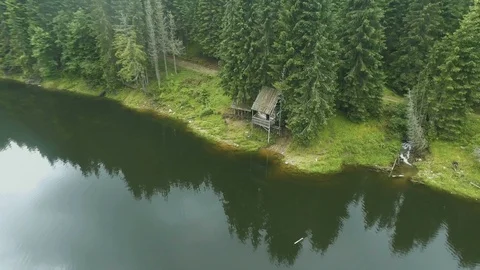 Aerial shot of a mountain lake cabin Stock Footage 94962853