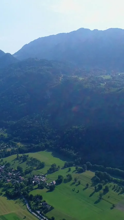 Aerial shot of a mountain lake with fields and villages around it Stock Footage 225552425