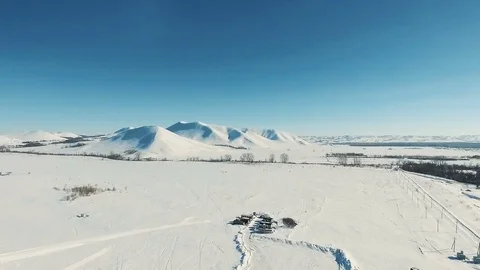 Aerial shot of mountains and fields by ski resort. Stock Footage 70299846
