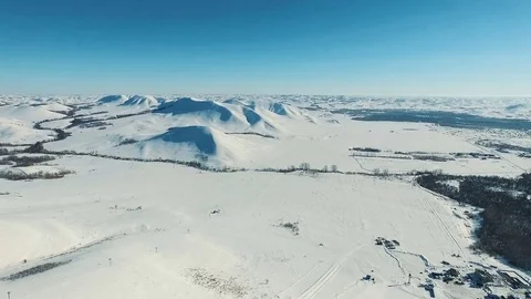 Aerial shot of mountains and fields by ski resort. Stock Footage 70316639